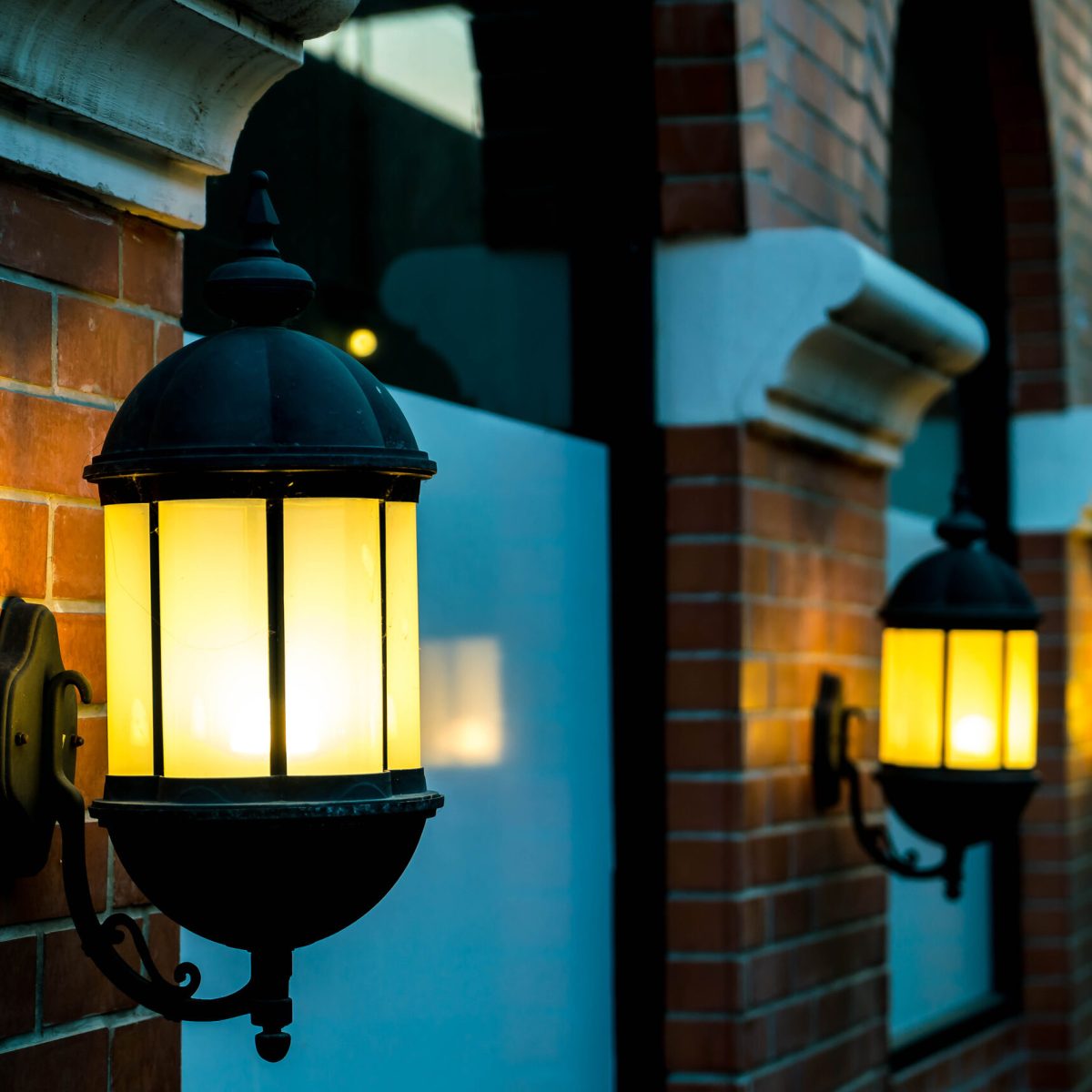 lamp against a red brick wall at night. Vintage filter