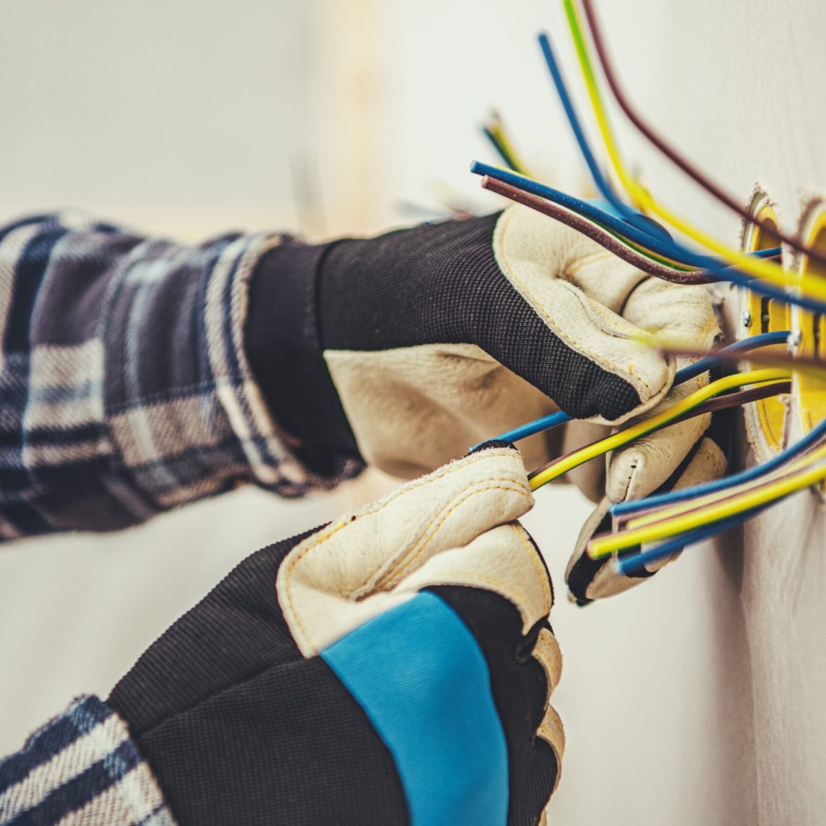 Residential Electric Outlets Installation in a Drywall. Electrician at Work.